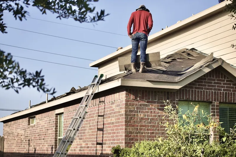 Professional roofer working on a residential roof in Kinnelon